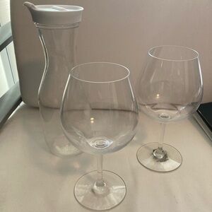 Two plastic wine goblets and decanter